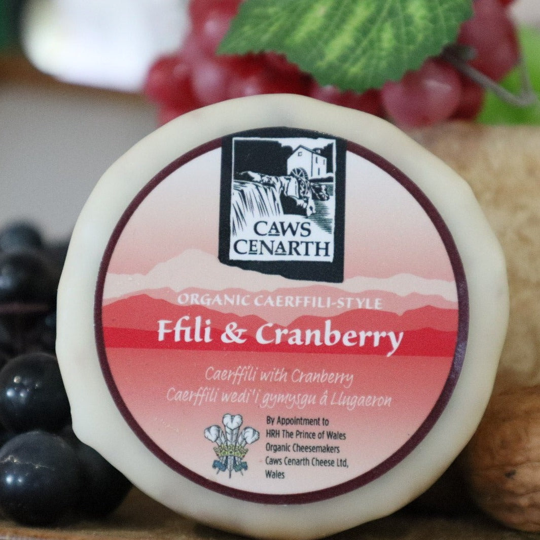 An image or organic Caerffili style Ffili and Cranberry against a background of grapes 